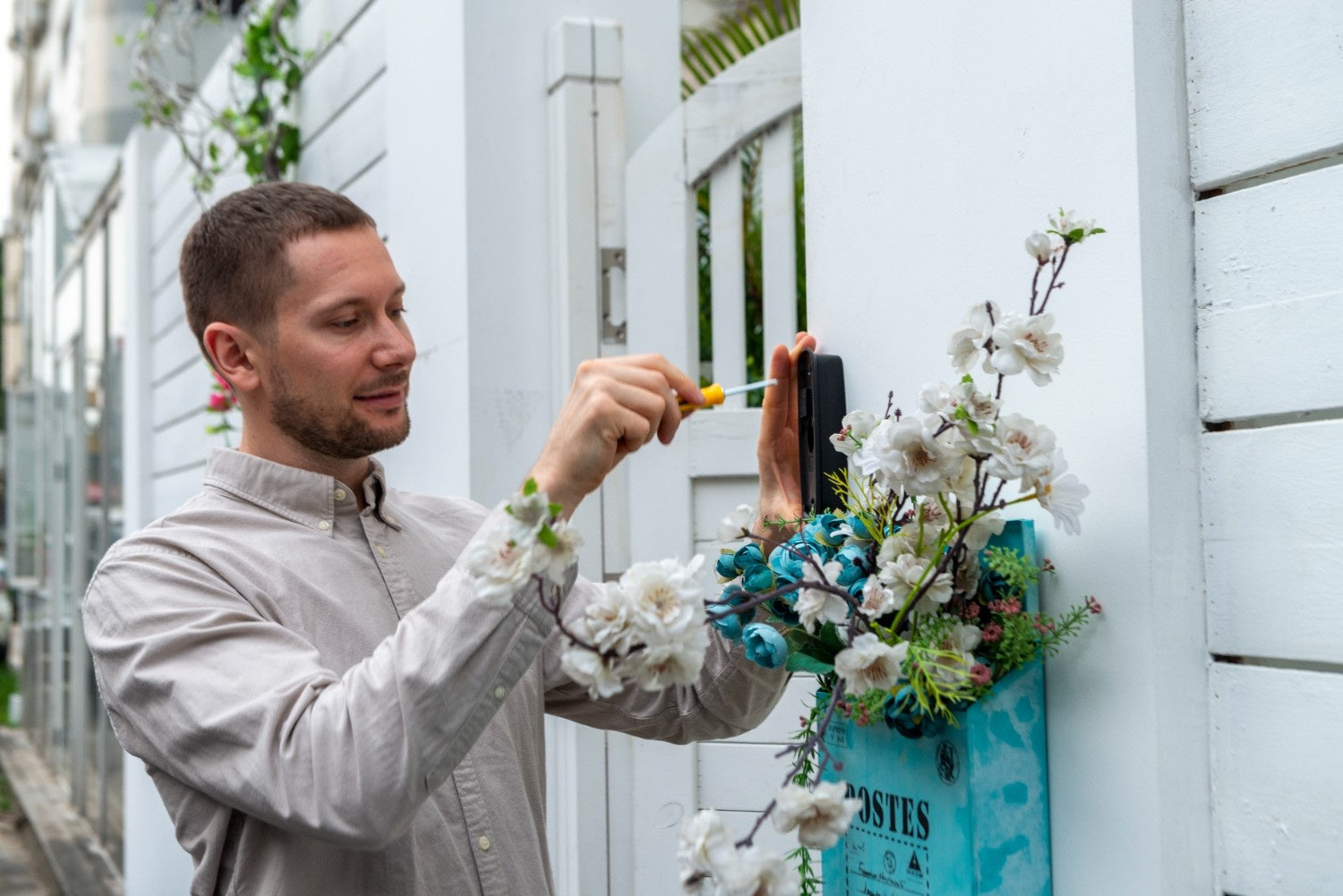 A man installing the anyfree hello doorbell at the door