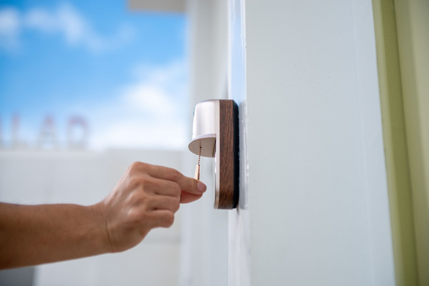 A man ringing the anyfree hello doorbell by pulling the chain