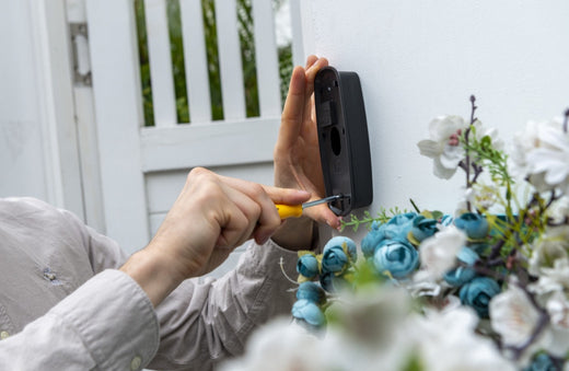 A man installing the anyfree hello doorbell - the wireless doorbell camera
